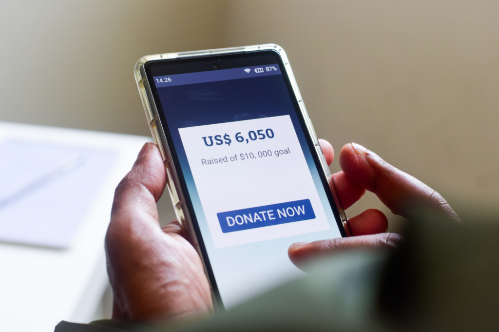 Person making a donation through their cell phone